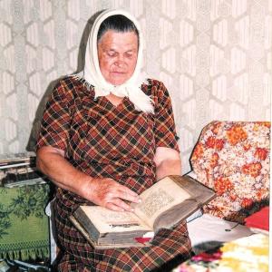 Брянск (Новозыбков). Воронок. П. И. С-на читает старинную книгу, 1998 г.